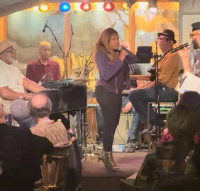 Adora Aiza performing on famous stage in Harlem, NYC where legends where first discovered