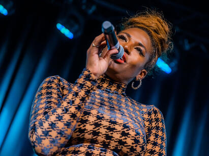 Adora Aiza singing live into microphone at luxury event Adora Aiza Live Singer